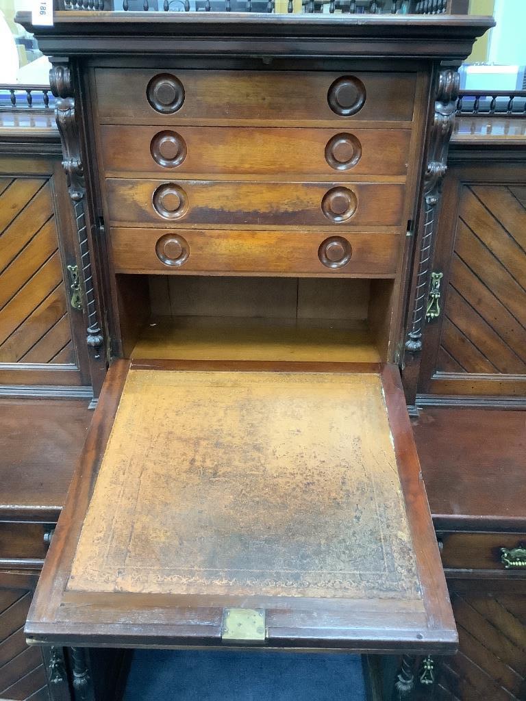 A late Victorian mahogany kneehole desk with fall front, width 151cm, depth 74cm, height 174cm